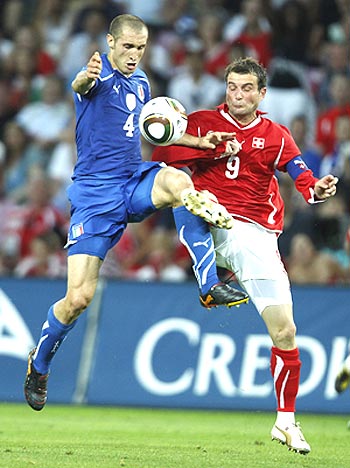 Italy's Giorgio Chiellini (left) and Switzerland's Alexander Frei vie for possession during their friendly tie in Geneva 