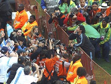 Diego Maradona blows kisses to fans before the match between Argentina and Nigeria on Saturday