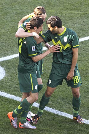 Slovenia's Robert Koren (left) celebrates with team-mates after scoring against Algeria
