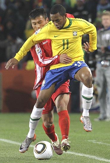 Brazil's Robinho (front) and North Korea's Pak Nam-chol vie for possession