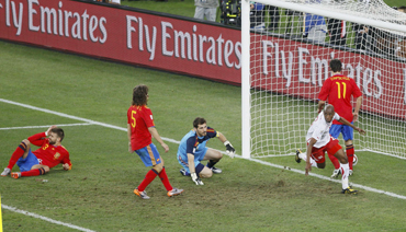 Switzerland's Fernandes celebrates after scoring against Spain's goalkeeper Casillas
