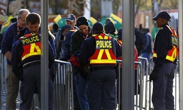 SA policemen search bags and control accreditations