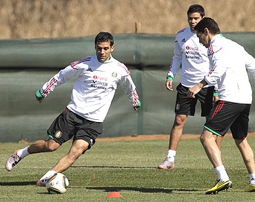 Mexico's Rafael Marquez (left) and teammates Guillemro Franco (right) and Pablo Barrera go through the grind during a practice session 