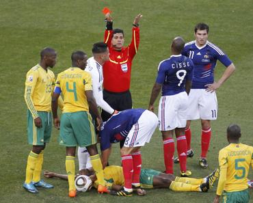 Referee Ruiz gestures after showing the red card to France's Gourcuff for a foul on South Africa's Sibaya