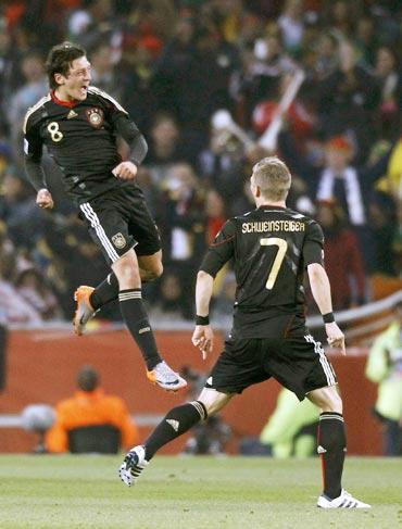 Mesut Ozil celebrates after scoring against Ghana