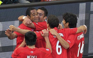 Chile players celebrate after scoring a goal