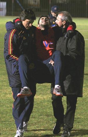 Spain's Raul Albiol is carried off after injuring  himself during a training session in Potchefstroom