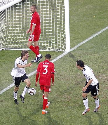 Thomas Mueller (left) celebrates with teammate Olic after scoring against England