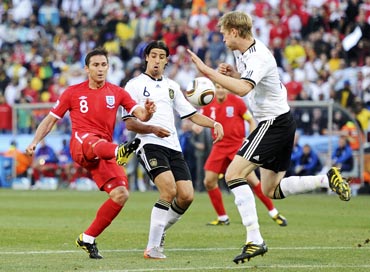 England's Frank Lampard (left) tries to score past German defenders