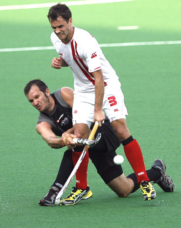 New Zealand's Blair Hopping (left) blocks Canada's Philip Wright as their vie for possession