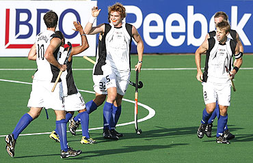 New Zealand's Andrew Hayward (centre) celebrates with team-mates after scoring the first goal