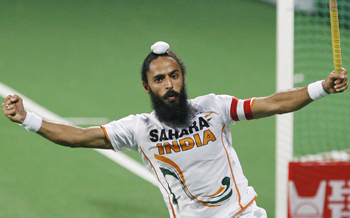 India's captain Rajpal Singh celebrates after scoring the second goal during their match against England