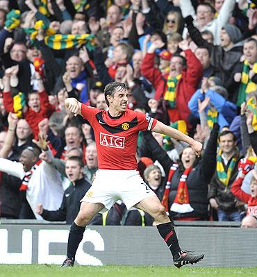 manchester united's gary neville celebrates after defeating liverpool