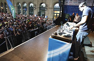 Jamaican Sprinter Usain Bolt plays DJ as he entertains the crowd at Zurich railway station