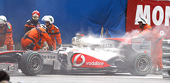 Smoke bellows out of Jenson Button's engine at the Monaco GP on Sunday