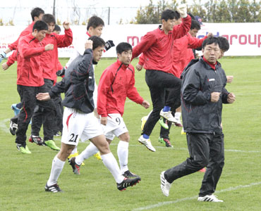 North Korea's head coach Kim Jong-hun (right) and his players go through the grind during a training session in Ayent in Western Switzerland