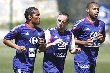 French players Florent Malouda (left) Franck Ribery (centre) and Thierry Henry go through the grind during a training session in Tignes