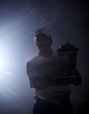 Francesco Molinari of Italy poses with his trophy after winning the WGC-HSBC Champions golf tournament