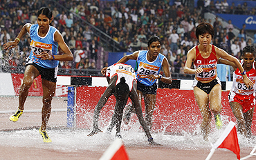 India's Sudha Singh (left) runs to claim the women's 300m steeplechase gold on Sunday