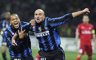 Inter Milan's Cambiasso celebrates with team-mate after scoring against Twente during their match at the San Siro