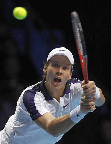 Tomas Berdych returns the ball to Roddick during their match at the ATP World Tour Finals in London