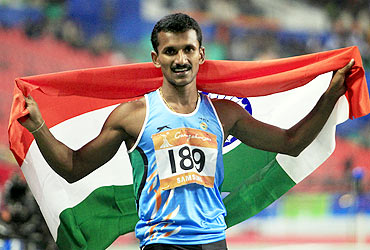 India's Joseph Ganapathiplackal Abraham celebrates winning the men's 400m hurdles final at the 16th Asian Games in Guangzhou