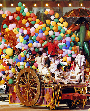 Performers sit in a cart as they take part in the opening ceremony