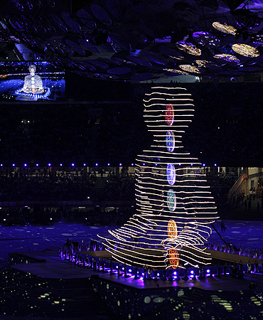 A light installation depicts a Yogic posture during the opening ceremony