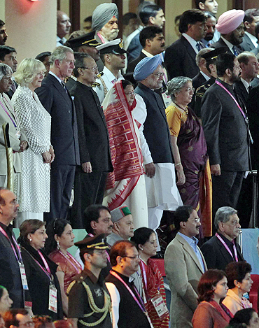 Camilla, Duchess of Cornwall, (from left to right) Britain's Prince Charles, India's President Pratibha Patil's, Patil's husband Devisingh Ramsingh Shekhawat, India's Prime Minister Manmohan Singh, Singh's wife Gursharan Kaur and Commonwealth Games Organising Committee chairman Suresh Kalmadi stand for the national anthem during the Opening Ceremony