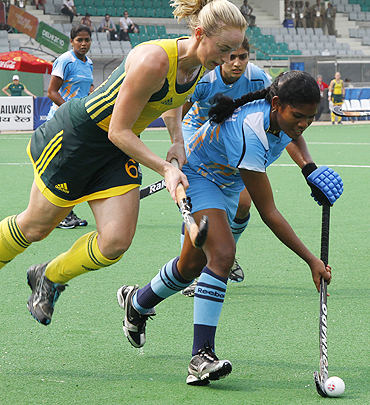 India's Subhadra Pradhan (right) goes past Australia's Megan Rivers during their group match