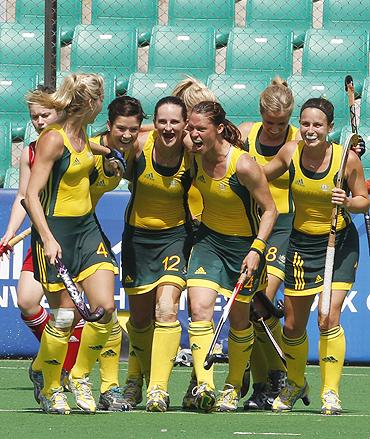 Australian players celebrate after scoring against England in their women's hockey semi-final tie on Monday