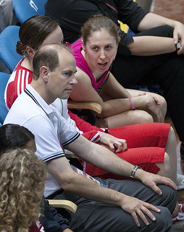 Australian diver Briony Cole chats with Britain's Prince Edward (left) during the men's three metre springboard diving at the Commonwealth Games in New Delhi on Monday