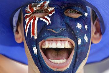 A New Zealand hockey fan cheers for his team during their bronze medal match against England