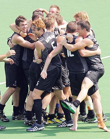 Kiwi players celebrate after beating England to claim bronze