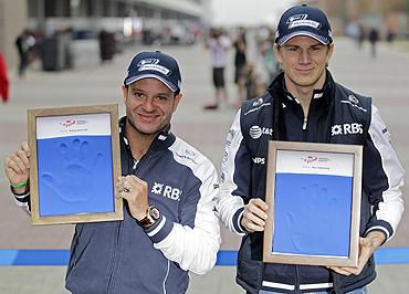 Williams' Formula One drivers Rubens Barrichello (left) and teammate Nico Hulkenberg display casts of their hands for the Driver Wall of Fame exhibition, at the South Korean F1 Grand Prix on Saturday