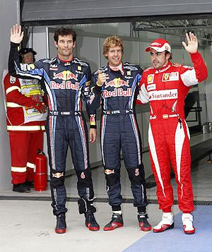 Red Bull's Sebastian Vettel celebrates winning pole position as he is flanked by teammate Mark Webber (left) and Ferrari's Fernando Alonso after qualifying at the Korea International Circuit in Yeongam on Saturday