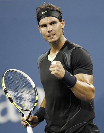Rafael Nadal of Spain celebrates winning a point against compatriot Feliciano Lopez