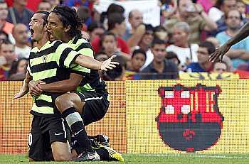 Hercules's player Nelson Valdez and Abel Aguilar celebrate a goal against Barcelona