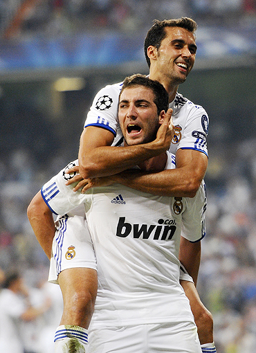 Real Madrid's Gonzalo Higuain (left) celebrates with team-mate Alvaro Arbeloa after scoring against Ajax on Wednesday