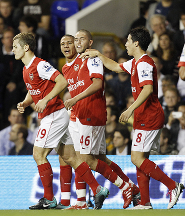 Arsenal's Henri Lansbury (centre) celebrates with teammates after scoring against Tottenham Hotspur during their League Cup match