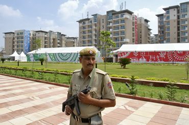 A policeman stands guard at the 2010 Commonwealth Games village
