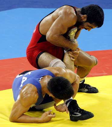 Sushil Kumar (in red) fights Leonid Spiridonov of Kazakhstan during their 66kg men's freestyle wrestling bronze medal match at the 2008 Beijing Olympics