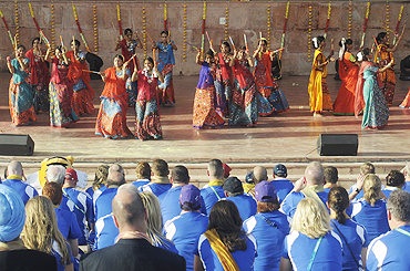 Athletes from Scotland watch a traditional dance during a cultural programme at the Games Village in New Delhi