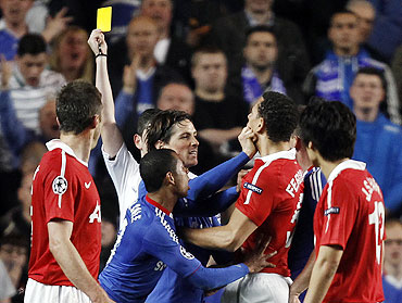 Manchester United's Rio Ferdinand (right) clashes with Chelsea's Fernando Torres