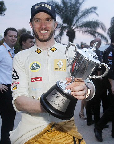 Renault's Nick Heidfeld holds his trophy in the paddock