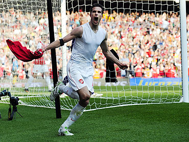 Robin van Persie celebrates after scoring against Liverpool