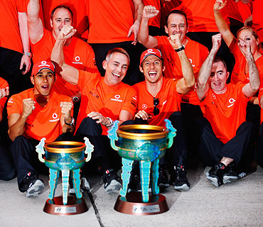 McLaren's Lewis Hamilton (left) celebrates in the paddock with teammate Jenson Button (second from right) and Team Principal Martin Whitmarsh (centre) after winning the Chinese Formula One Grand Prix on Sunday