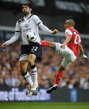 Tottenham's Vedran Corluka (left) is challenged by Arsenal's Gael Clichy during their  EPL match on Wednesday