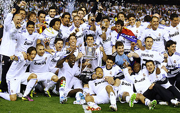Real Madrid players celebrate with the trophy after beating Barcelona to clinch the King's Cup final on Wednesday
