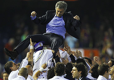 Real Madrid players celebrate with coach Jose Mourinho after winning the Copa del Rey final against Barcelona